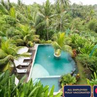 an overhead view of a pool in a tropical forest at Alamdini Resort Ubud