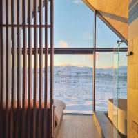 a bedroom with a view of the ocean at Iceland Lakeview Retreat, Selfoss