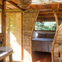 a bedroom in a tree house with a bed in it at Cabana del Rio Lejos Pijao, Finca Flora del Rio
