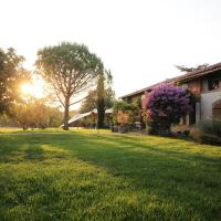 a grassy yard next to a house with the sun setting at Chambre d'hôtes Belair, Muret