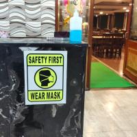 a sign that says safety first wear mask in a restaurant at Hotel Chetan International, Bangalore