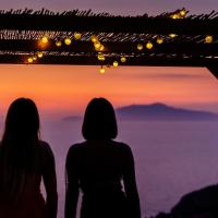 two women standing on top of a mountain watching the sunset at Hotel Il Girasole, Anacapri