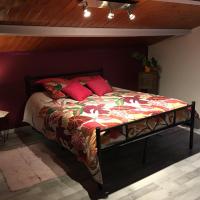 a bedroom with a large bed with red pillows at Le Welcome, Coutras