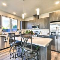 a kitchen with stainless steel appliances and wooden cabinets at Modern Troutdale Townhome 15 Miles to Portland!