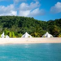 a group of white tents on a beach at Wild Lotus Glamping, Bolans