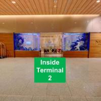 an empty lobby with a inside terminal sign in a building at Niranta Transit Hotel Terminal 2 Arrivals/Landside, Mumbai