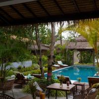 a patio with tables and chairs and a swimming pool at Amaya Boutique Resort, Ko Phangan