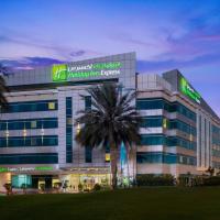 a hospital building with a palm tree in front of it at Holiday Inn Express Dubai Airport, an IHG Hotel