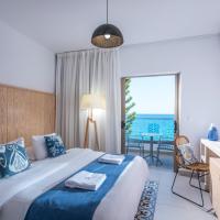 a bedroom with a bed and a view of the ocean at Enorme Serenity Spritz - Adults Only, Hersonissos