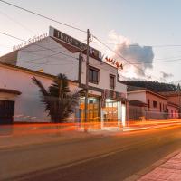 a street with a building with a fire in the background at Hotel Salinero - Zipaquirá
