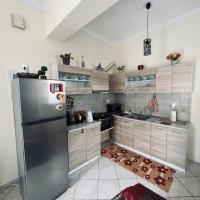 a kitchen with a stainless steel refrigerator at See and City Apartment, Aigio