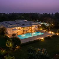 Whispering Palms by StayVista - Pool-view villa with Boutique interiors, Terrace & Lawn