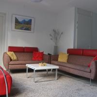 a living room with two couches and a table at Heerenveen zonnige hoekwoning met tuinkamer en eigen parkeerplaats