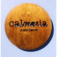 a wooden surfboard with the name calima on it at Calmaria Guesthouse, Porto Covo