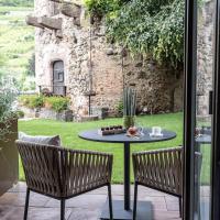 a patio with a table and two chairs and a table at Relais et Châteaux Le Chambard, Kaysersberg