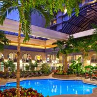 a hotel lobby with a large pool and palm trees at Sheraton Atlanta