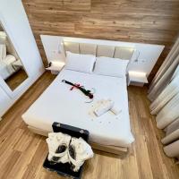 a small room with a white bed with a hammer andweapons at Hotel Gran Sasso & SPA, Teramo