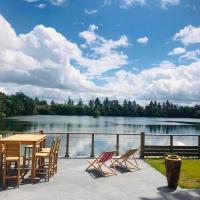 a patio with a table and chairs next to a lake at Domaine le lac bleu, Coutras