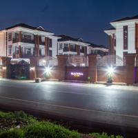 a city street at night with buildings and lights at Macoba Luxury Apartments, Kumasi