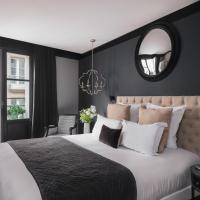 a bedroom with a large bed and a mirror at Maisons du Monde Hotel & Suites - Nantes