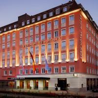a large red building with an american hotel at Eden Hotel Wolff, Munich
