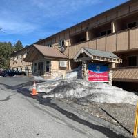 a pile of snow in front of a building at SureStay Plus Hotel by Best Western Mammoth Lakes