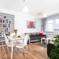 a living room with a table and chairs and a couch at Apartamenty Niko, Zator