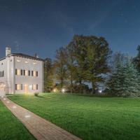 a white house on a grassy field at night at Monteborre, Cento
