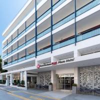 a large white building with a store front at Best Western Plus Hotel Plaza, Rhodes Town