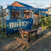 a blue food truck with a table and two chairs at Bunker Hostel, Cabo Polonio