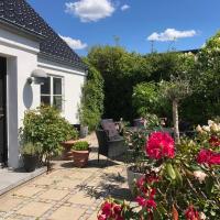 a patio with flowers and plants in front of a house at Helts B&B - Helts Guesthouse, Herning