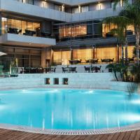a large swimming pool in front of a building at Galaxy Iraklio Hotel, Heraklio