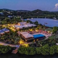 an aerial view of a resort on the water at night at Gunpowder House & Suites, English Harbour Town