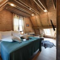 a bedroom with a bed in a room with wooden walls at Ethno Houses Plitvice Lakes Hotel, Plitvica Selo