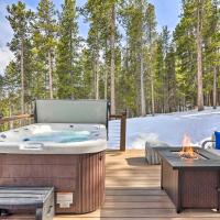 a hot tub on a deck with a fire pit at Modern Private Mtn Retreat with Hot Tub and Fire Pit!, Evergreen