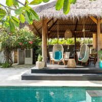 a resort with a swimming pool and chairs and a thatch roof at Tigerlillys Boutique Hotel, Nusa Lembongan