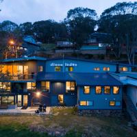 a large blue house with its lights on at Diana Alpine Lodge, Falls Creek