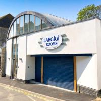 a large white building with a garagelords sign on it at Largigi, Free Parking, Close to the Beach and Town Centre Rooms, Lyme Regis
