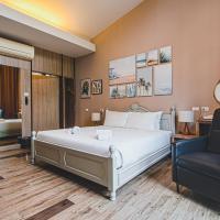 a hotel room with a bed and a chair at Lumphawa Amphawa, Samut Songkhram