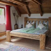 a bedroom with a wooden bed in a room at Tiefala's Eck, Stubenberg