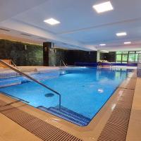 a large swimming pool in a hotel room at Hotel Escalade, Poiana Brasov