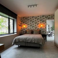 a bedroom with a bed and a large window at Mooi, rustig en luxueus appartement 5km van Leuven, Haacht