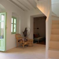 a room with stairs and a chair and a table at Peaceful 2 bedroom heritage vacation house, Nikiá