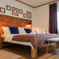 a bedroom with a large bed with a wooden headboard at B&B Lower Lakes Plitvica Selo