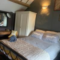 Double bedroom with king-sized bed, shower room and lounge in pretty cottage