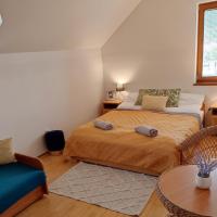 a small bedroom with two beds and a table at Penzion u Sulov, Ružomberok