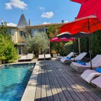 a swimming pool with chairs and a red umbrella at Le Clos Réaud, Blaye