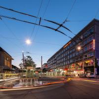 a city street at night with traffic at Continental Hotel Lausanne