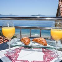 a table with two glasses of orange juice and croissants at Beach House Poseydon, Mlini