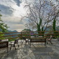 a patio with tables and chairs and a fence at Thalassoxyla Thalassa, Tsagarada